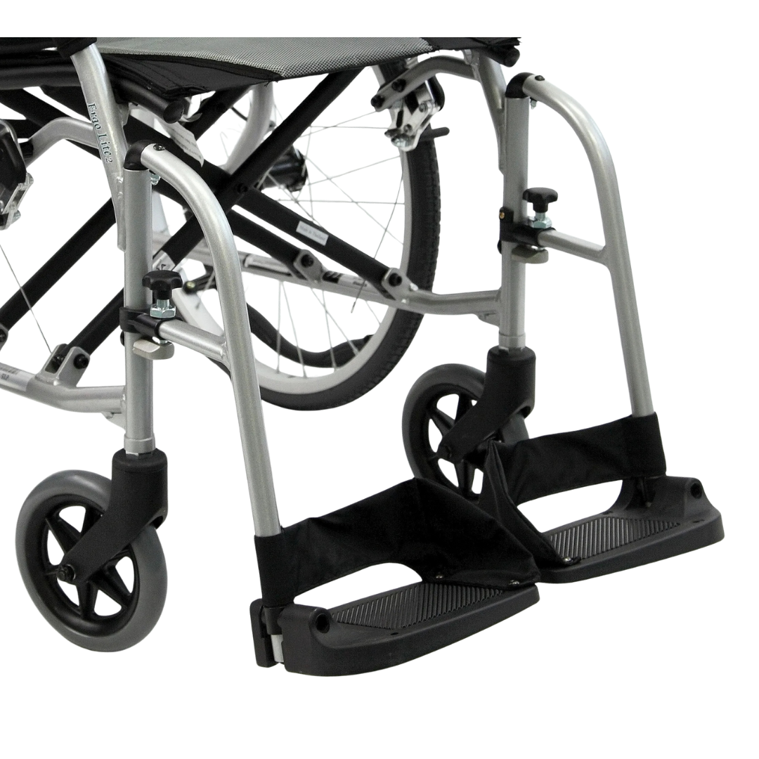 Close-up of Karman Healthcare Footrests for ERGO Flight models, highlighting the footrests, black fabric seat supports, and front caster wheels against a white background.